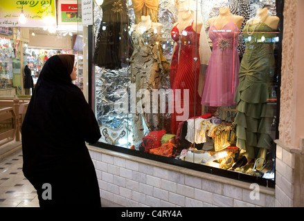 Young Iranian woman with chador looking at dresses in a fashion store inside a shopping mall in Zanjan, Iran. Islamic people life in a muslim country Stock Photo