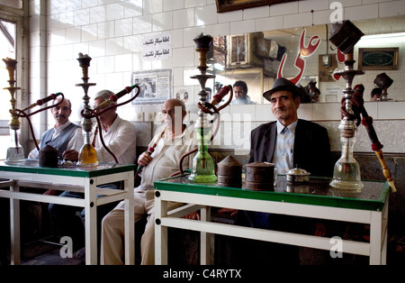 Old men smoking water pipe in a traditional tea house in Tabriz (East Azerbaijan province, Iran) Stock Photo
