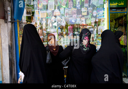 Group of four Iranian women looking at a shop window in Rasht, Iran Stock Photo