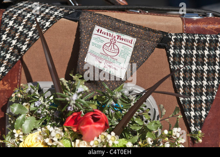 Three tweed flags hang in front of a colourful flower basket at the London Tween Run, 2011 Stock Photo