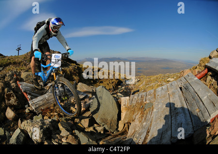 Red Bull sponsored professional trials bike rider Danny MacAskill races his mountain bike at a downhill event in Scotland Stock Photo