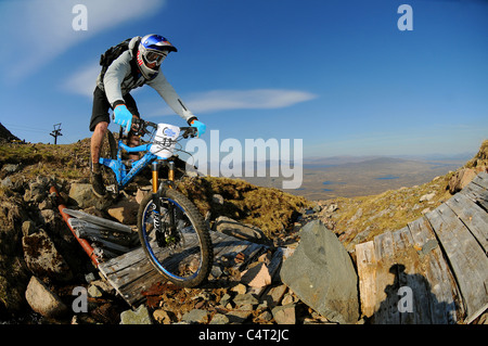 Red Bull sponsored professional trials bike rider Danny MacAskill races his mountain bike at a downhill event in Scotland Stock Photo