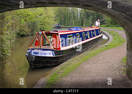 Narrowboat about to go under bridge over Trent and Mersey Canal at Great Haywood near Shugborough Staffordshire England Stock Photo