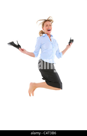 businesswoman jumping with shoes in hand Stock Photo