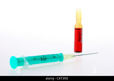 Injection cannula, medical syringe, filling a syringe with a medicament from a vial. Stock Photo