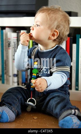 Little boy, 1 year old, is exploring his home. curiously exploring the apartment. Stock Photo
