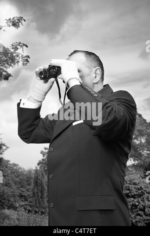 Old fashioned man with binoculars horse race. Stock Photo