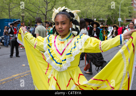 A young Mexican-American girl in a colorful dress in the 2011 Cinco de Mayo parade in New York City Stock Photo