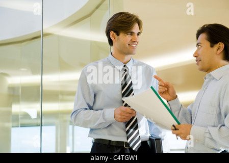 Businessmen discussing document Stock Photo