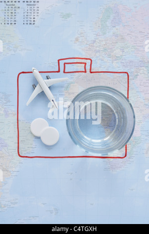 Pills, Glass, Toy Plane and Map Stock Photo