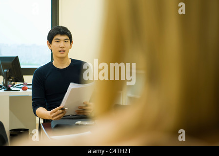 Young office worker sitting in meeting Stock Photo