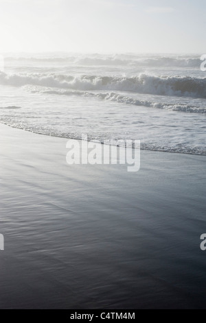 Waves washing onto shore Stock Photo