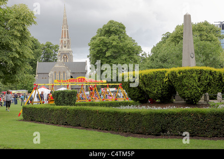 Funfair swings and amusements at Turnham Green in Chiswick on what was an overcast day in London. Stock Photo