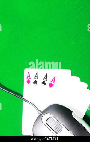 An online gaming concept with computer mouse, four aces and green felt Stock Photo