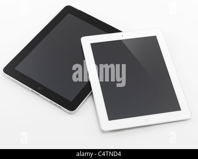 White Apple iPad 2 and black iPad tablet computers. Isolated on white background. Stock Photo