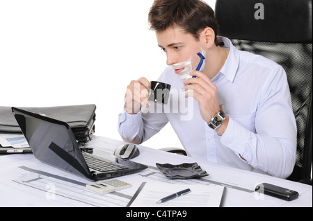 Businessman shaves in the workplace Stock Photo