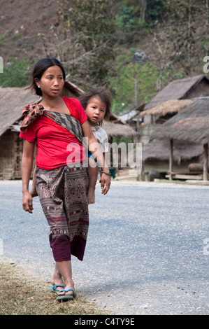 Mather and daughter walking in the streets of a small village near Viang Vieng, Laos Stock Photo
