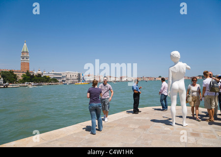 Punta della Dogana with Charles Ray's sculpture Boy with Frog against view of Venice with Giardini ex Reali, Venice, Italy Stock Photo