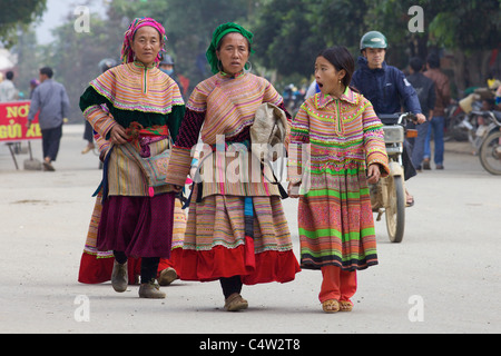 Three women of the Flower Hmong Ethnic Minority People walking in Bac Ha Vietnam Stock Photo