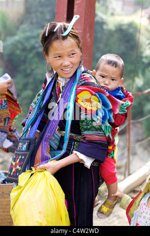 Black Hmong Ehtnic Minority Woman carrying Child in Vietnam Stock Photo