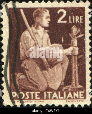 ITALY - CIRCA 1953: A stamp printed in Italy shows a man kneeling, series, circa 1953 Stock Photo