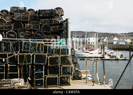 Lobster pots stacked up on Aberystwyth quayside alongside the marina. Stock Photo