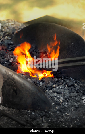 Blacksmith heating up iron in furnace - detail Stock Photo