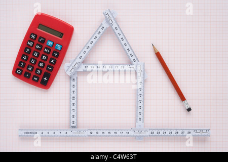 Folding Ruler in Shape of House with Pencil and Calculator Stock Photo
