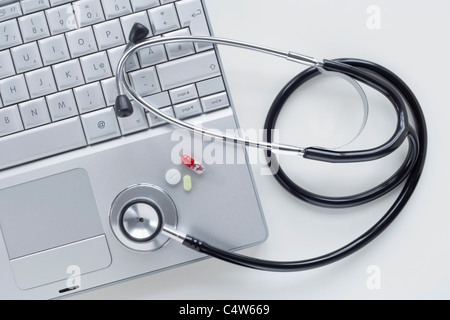 Laptop Computer with Stethoscope and Pills Stock Photo