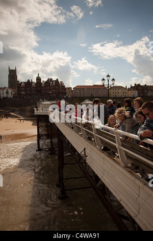 People on Cromer pier a popular holiday resort in Norfolk East Anglia England Stock Photo