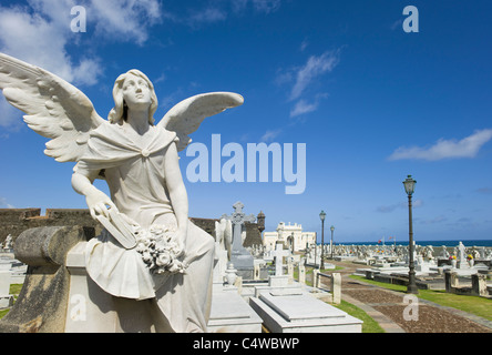 Puerto Rico, Old San Juan, Santa Maria Magdalena Cemetery with El Morro Fortress in background Stock Photo