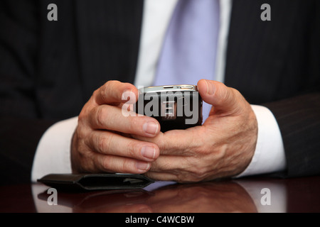 Man using mobile phone, close-up of hands. Stock Photo