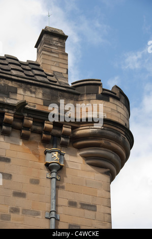Scotland, Edinburgh. Historic Edinburgh Castle, castle wall detail with 1887 drain pipe with royal lion. Stock Photo