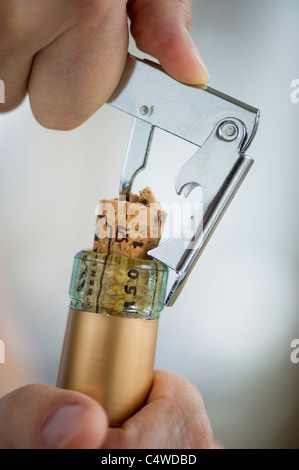 Man opening wine bottle Stock Photo