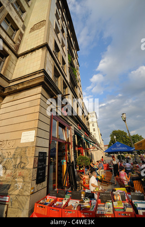 Book shop and street café, Karl-Marx-Allee, Frankfurter Allee, former Stalinallee, Friedrichshain, Berlin, Germany. Stock Photo