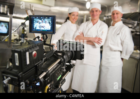 USA,New York State,New York City,Three chefs posing in kitchen,camera in foreground Stock Photo