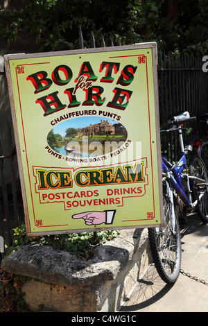 A sign advertises boats for hire and chauffeured punts on the waterways of Oxford in England.