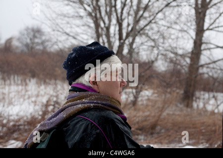 Active 62 year old woman hikes in the winter. Stock Photo
