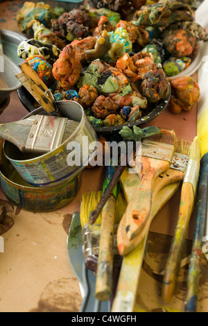 An encaustic artist has tools on her bench, including blobs of wax she melts before applying to canvas. Stock Photo