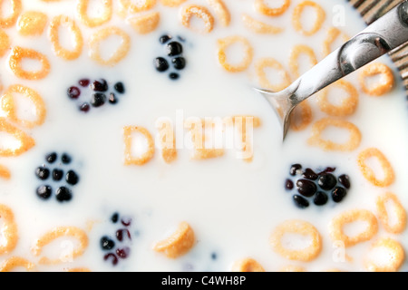 The word DIET spelled out of letter shaped cereal pieces floating in a milk filled cereal bowl. Stock Photo