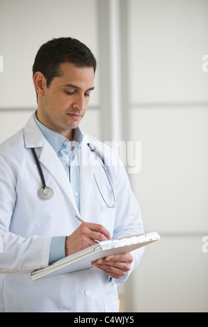 USA, New Jersey, Jersey City, doctor writing in notepad Stock Photo