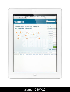 White Apple iPad 2 tablet computer with Facebook home page on its display. Isolated with clipping path on white background. Stock Photo