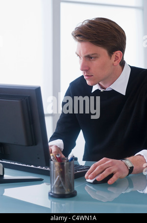 USA,New Jersey,Jersey City,man working on computer at office Stock Photo