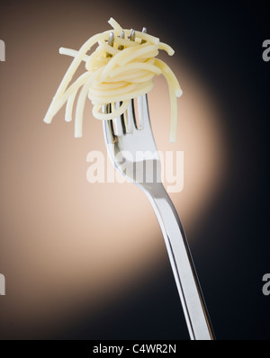 Close up of fork with spaghetti on black background Stock Photo