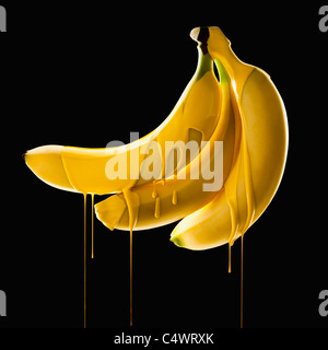 Studio shot of bananas covered with yellow paint Stock Photo