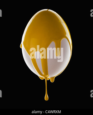 Studio shot of egg covered with yellow paint Stock Photo