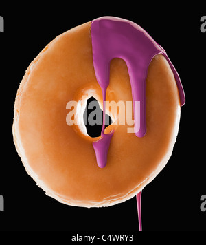 Studio shot of doughnut with purple paint Stock Photo