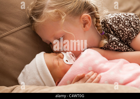 USA,Utah,Lehi,Girl (2-3) embracing baby sister on sofa Stock Photo