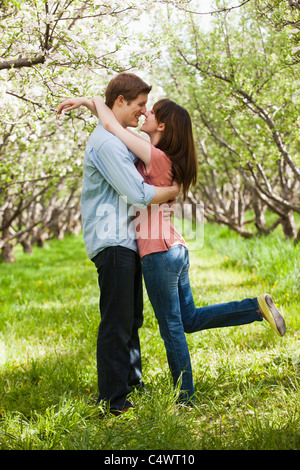 USA,Utah,Provo,Young couple embracing in orchard Stock Photo