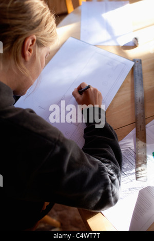 USA, California, Female architect drawing plans Stock Photo